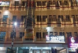 Hotel Shivam Grand Inn lit up at night