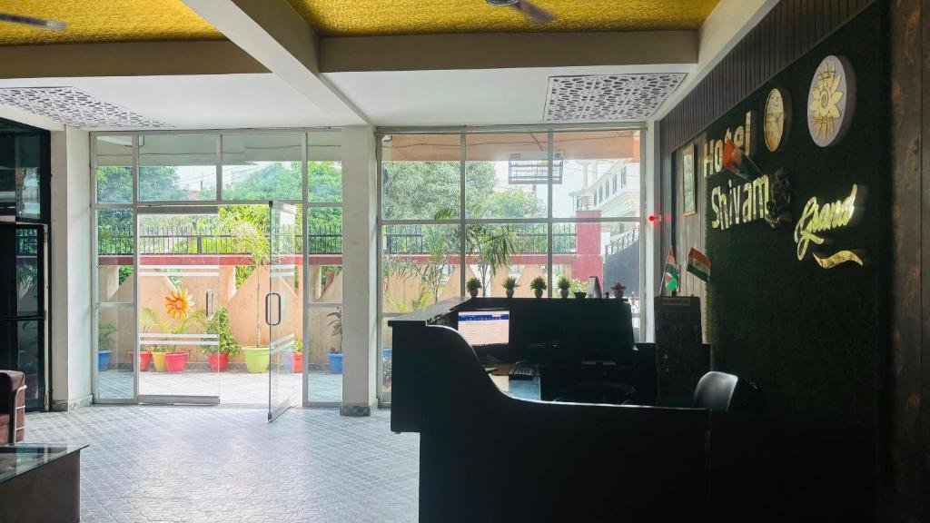 Sunlit lobby and reception of Hotel Shivam Grand Inn